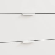 Close-up of two white drawer fronts with slim recessed handles