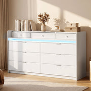 White chest of drawers styled with books, plants and boxes on top, blue LED on