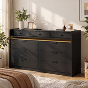 Black chest of drawers with warm LED strip in a bright bedroom
