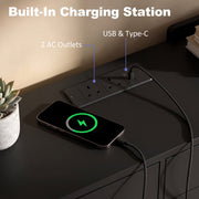 Built-in charging station on a black top with 2 UK outlets, USB and Type-C ports