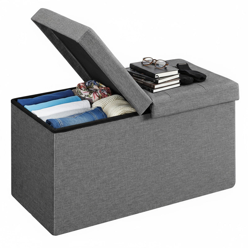 Dark grey ottoman bench with flip lid open showing storage interior