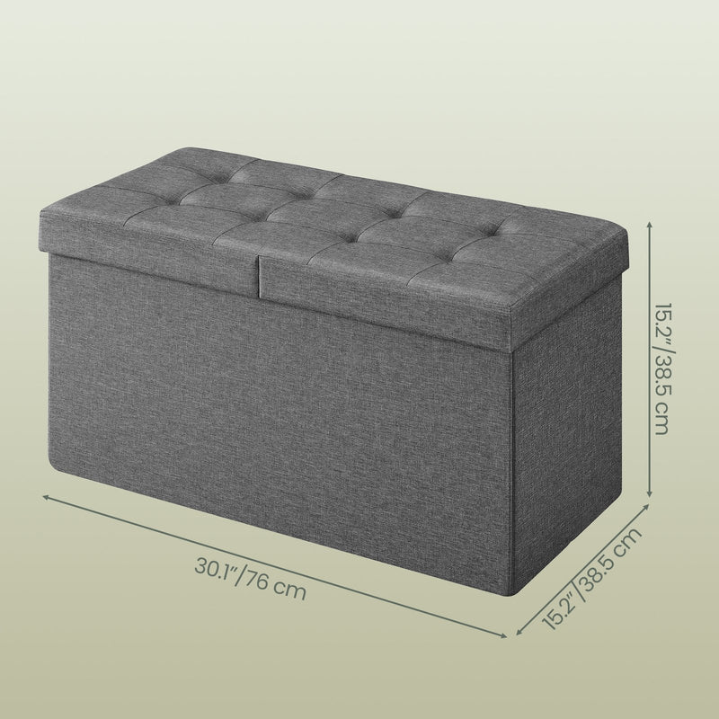 Close-up of the button-tufted top on the dark grey storage ottoman