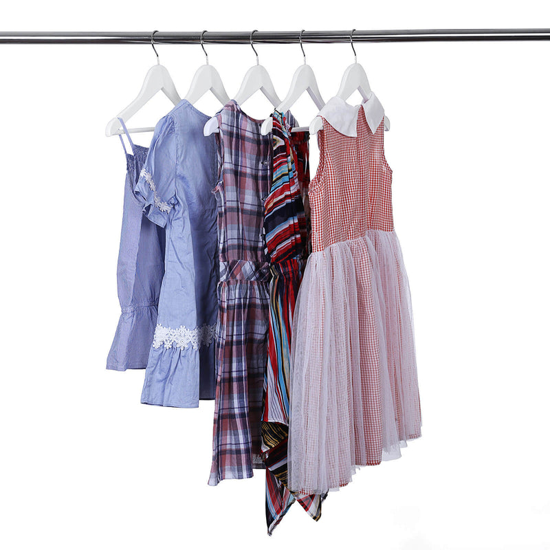 Girls' dresses and a checked shirt hung on white hangers on a metal rail