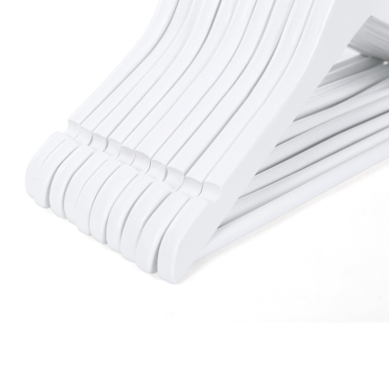 Angled close-up showing how slimly the white wooden hangers stack