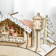 Close-up of the lit chalet and lamp post on top of the sleigh