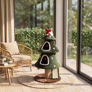 Christmas tree cat tower in a sunroom next to a rattan chair