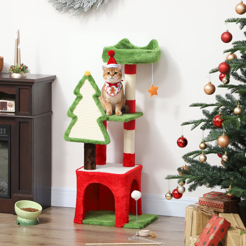 Christmas cat tree with a cat in a Santa hat on the platform beside a Christmas tree