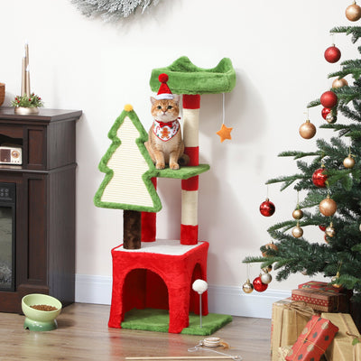 Christmas cat tree with a cat in a Santa hat on the platform beside a Christmas tree