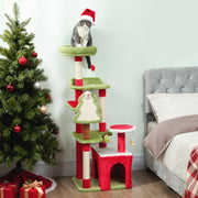 Christmas cat tree with a cat in a Santa hat on the top perch beside a Christmas tree