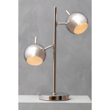 Chrome twin light table lamp with two round shades in a room