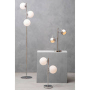 Chrome two light table lamp on a bedside table