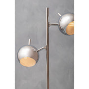 Chrome twin light lamp styled on a sideboard