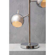 Chrome two light table lamp on a desk