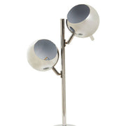 Close-up of chrome round shade on twin light table lamp