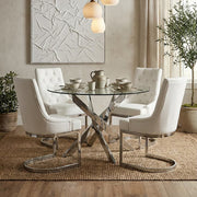 Chrome round glass dining table set for a meal with chairs