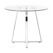 Clear glass round dining table with silver metal base on a plain background