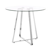 Round glass top dining table with silver metal base, studio shot