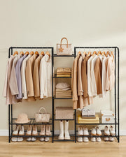 Open wardrobe hanging rail with clothes styled in bedroom