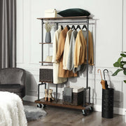 Industrial clothing rack with jackets, storage baskets and an umbrella stand by a grey wall