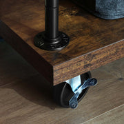 Close-up of a braked castor fitted under the rustic brown base board