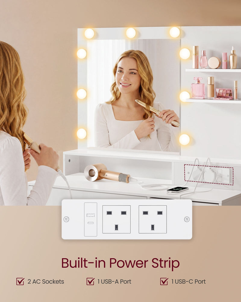 Woman styling her hair at the dressing table beside the built-in power strip with USB and plug sockets