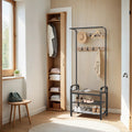 Camel brown and black hall tree beside an open wardrobe in a bright hallway