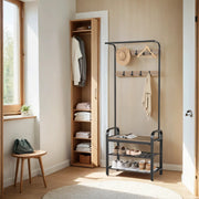 Camel brown and black hall tree beside an open wardrobe in a bright hallway
