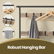 Close-up of the steel hanging bar with wooden hangers and a coat on a hook