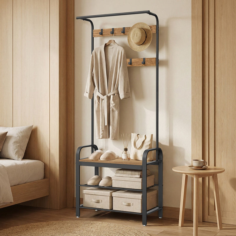 Honey brown hall tree in a bedroom corner with a dressing gown, hat and bag hanging up and storage boxes on the shelves