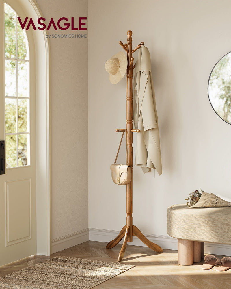Wooden coat rack stand by a hallway front door holding a hat, coat and handbag
