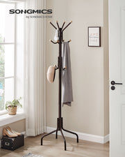 Coat stand styled in a bright hallway with coats and bags hanging