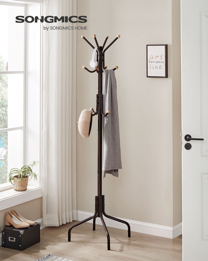 Coat stand styled in a bright hallway with coats and bags hanging