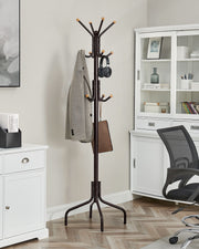 Coat stand in a home office corner with jacket, headphones and bag