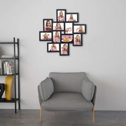 Black collage frame on a white living room wall beside a grey armchair