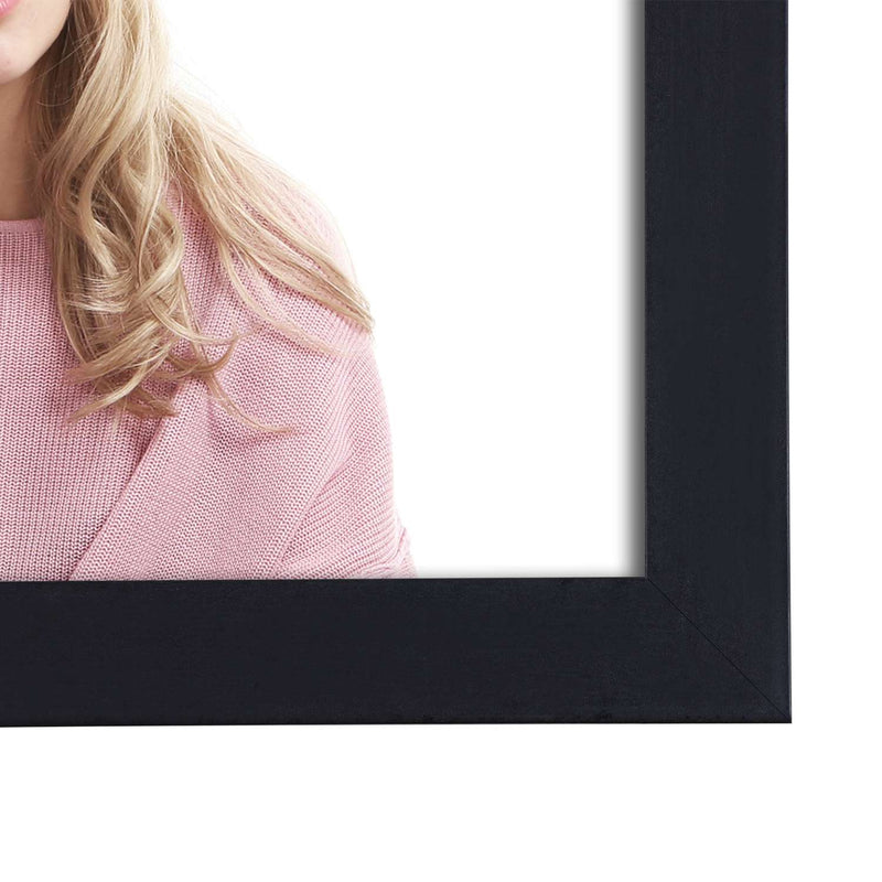Close-up of the black frame moulding beside a model in a pink jumper