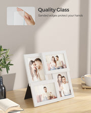 White frame resting on a wooden surface with a hand touching its glass front