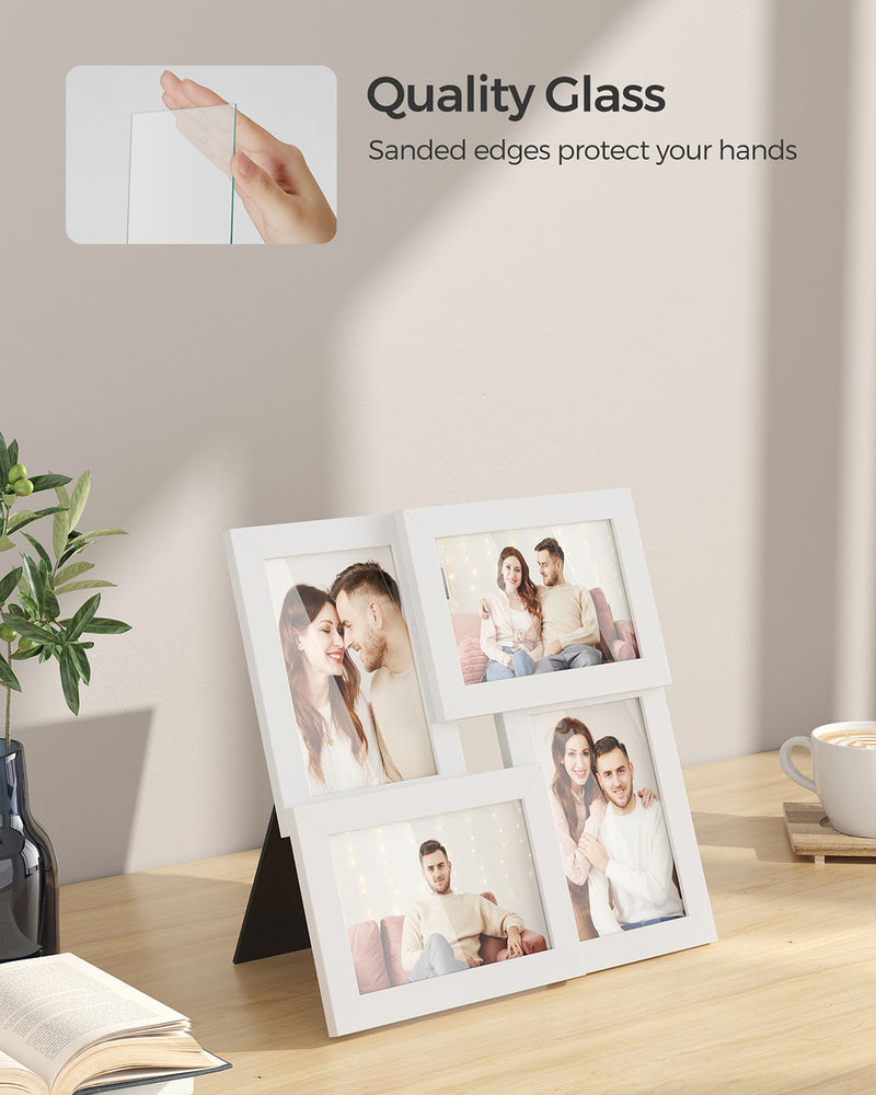 White frame resting on a wooden surface with a hand touching its glass front