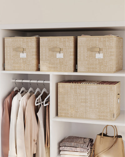 Sand Beige storage boxes lined up on wardrobe shelves above hanging clothes