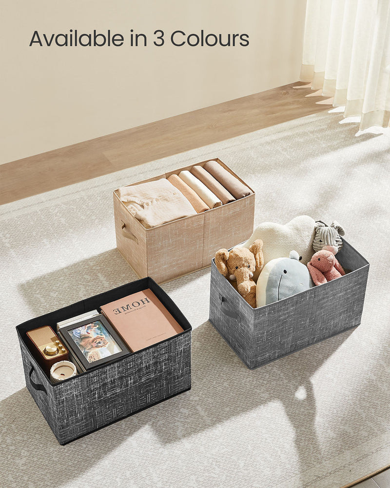 Storage boxes on a bedroom floor holding books, toys and folded clothes