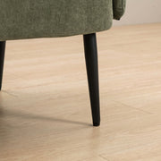 Close-up of a black tapered metal sofa leg on a light wood floor