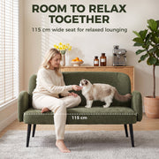 Woman and cat on the green sofa with the 115 cm wide seat marked