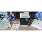 HOMCOM compact dehumidifier on a desk with instruction manual and accessories