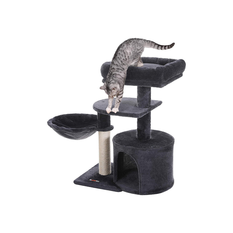 Cat resting inside the cave at the base of the cat tree
