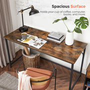 Desk top holding a lamp, coffee cup, books and a plant across its width