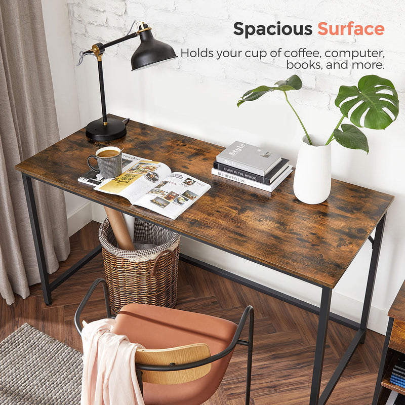 Desk top holding a lamp, coffee cup, books and a plant across its width