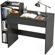 Black desk with an open book, desk lamp and shelves of books on a white background