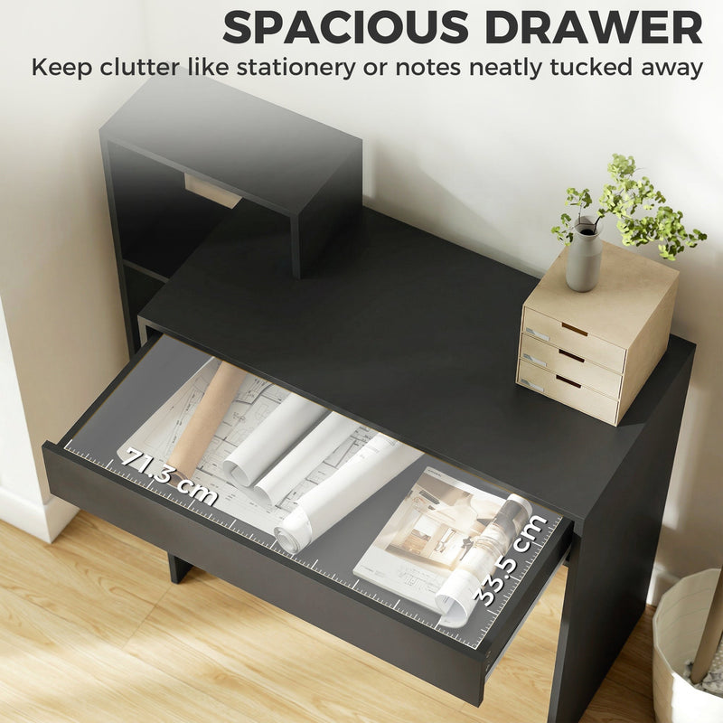Open desk drawer holding paper and stationery