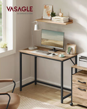 Angled view of the Vasagle computer desk showing the steel frame and wood-effect tabletop