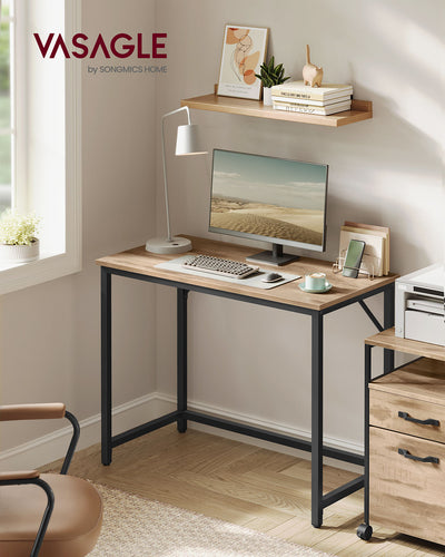 Angled view of the Vasagle computer desk showing the steel frame and wood-effect tabletop