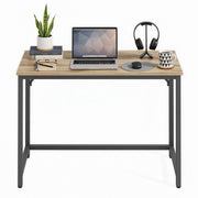 Vasagle desk styled with a laptop, plant, and desk accessories